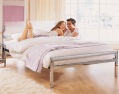 Contemporary designed chrome-plated futon-style bedstead with a perspex headboard. Wooden slatted